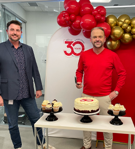 Corey and Joe with 30th Anniversary balloons and cake